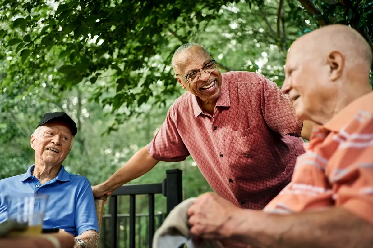 independent-living-vs-55-plus-natomas-rose-arbor-village Seniors enjoying conversation outdoors at an independent living community in Natomas